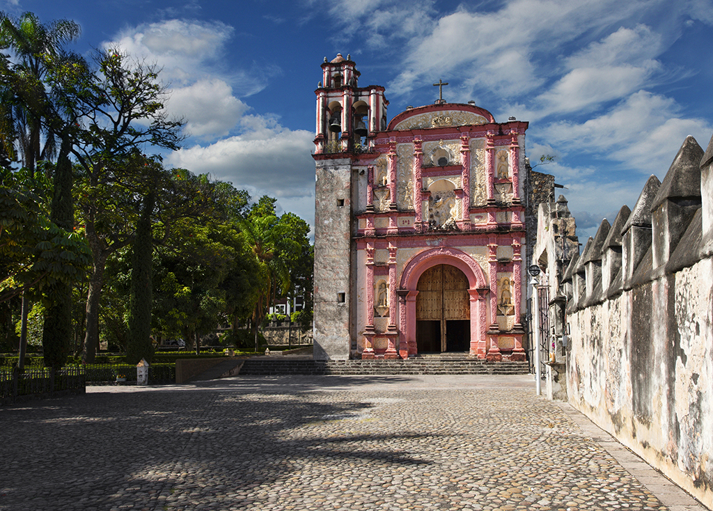 Cuernavaca, Mexico, November 28, 2016: The chapel located next to the Cathedral La Asuncion was bulit in 1722 by Enrique de Jeres, a Franciscan friar. Remarkable is the pink color of the facade.